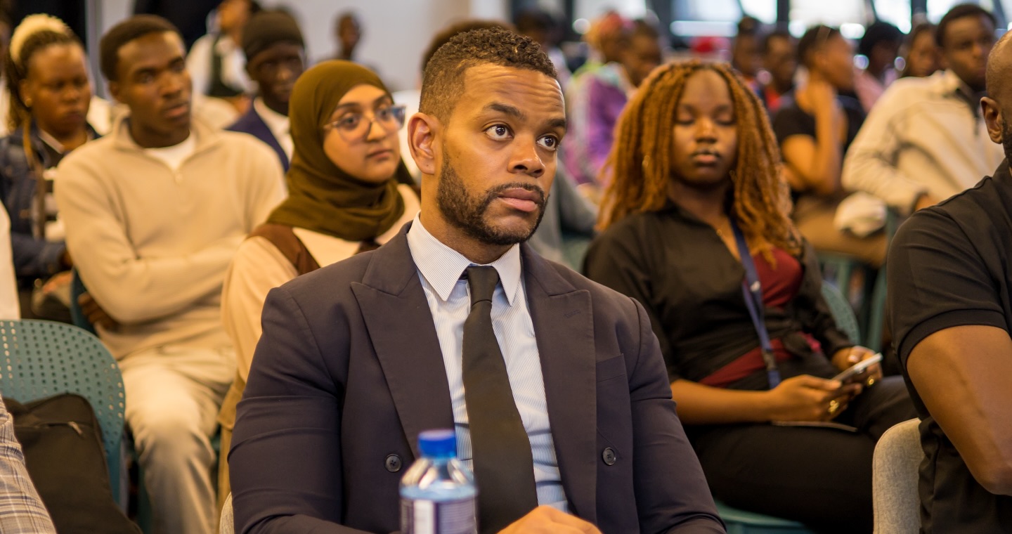 A judge listening closely during a pitch at the summit