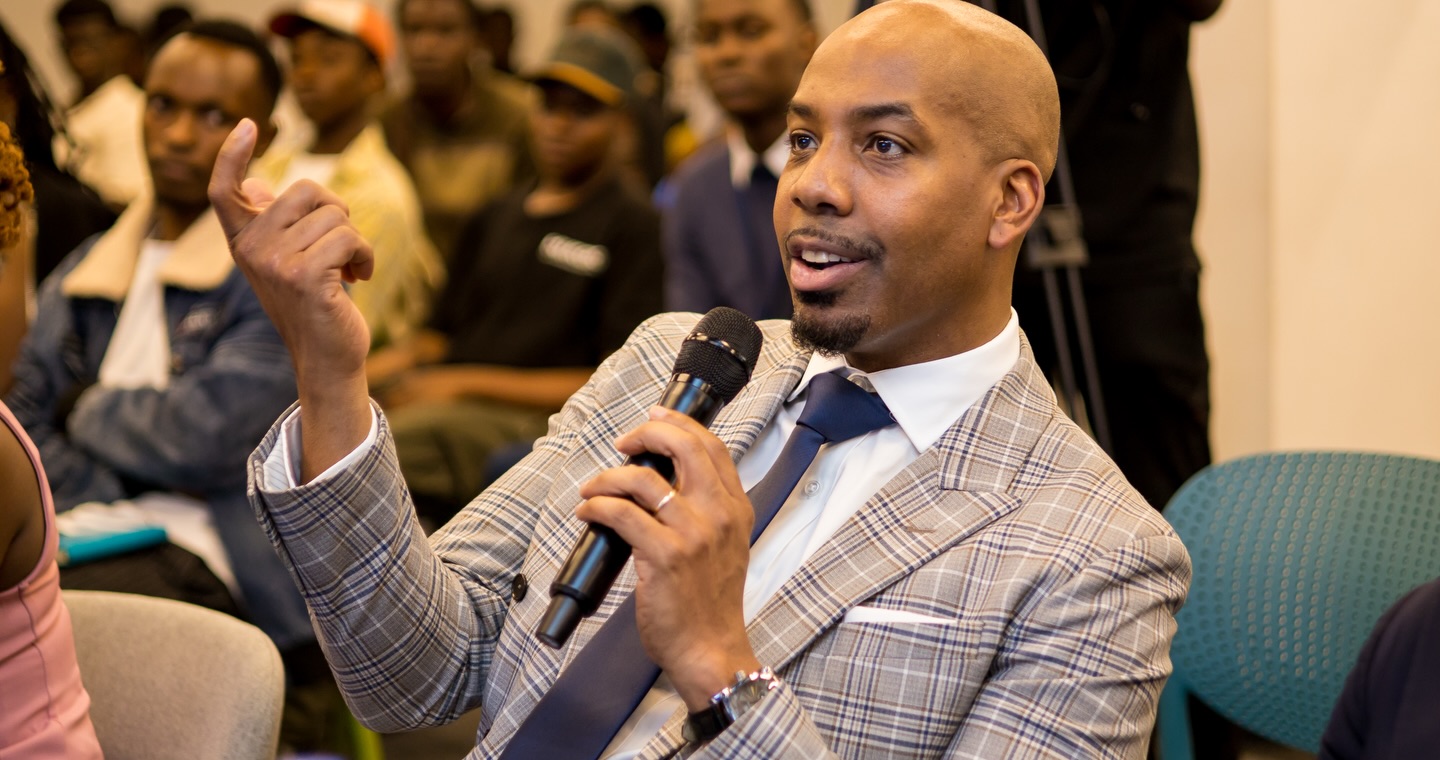 A judge speaking into a microphone during the summit panel conversation